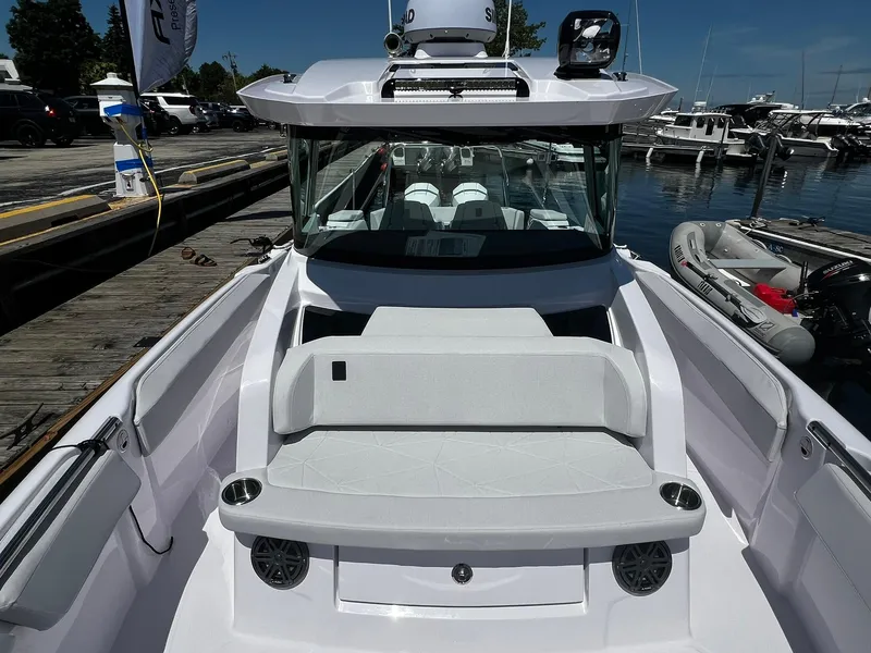 Slide: The Image of 2025 Axopar 29 CCX boat docked, featuring sleek design and comfortable seating. - 12