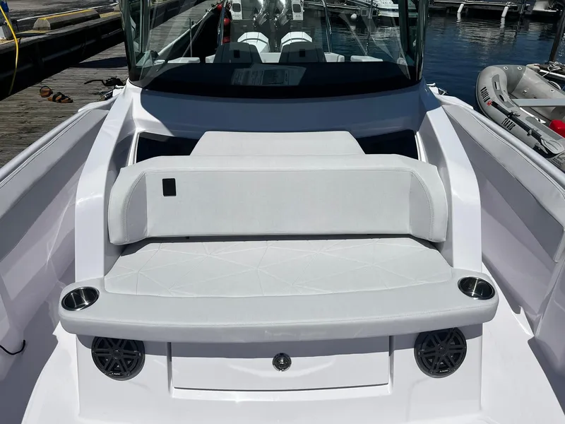 Slide: The Image of 2025 Axopar 29 CCX boat interior with white seating and cup holders. - 13