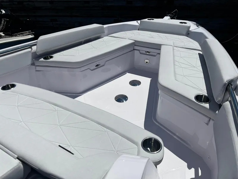 Slide: The Image of 2025 Axopar 29 CCX boat interior with cushioned seating and cup holders. - 4
