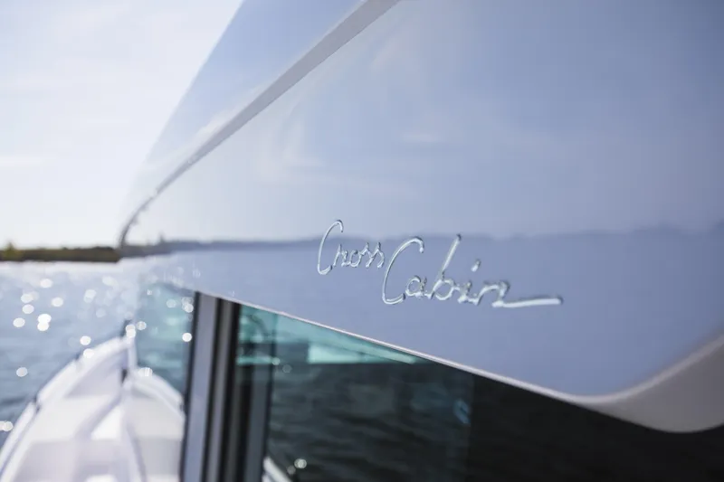 Slide: The Image of 2025 Axopar 37 XC CROSS CABIN boat detail with "Cross Cabin" logo. - 23