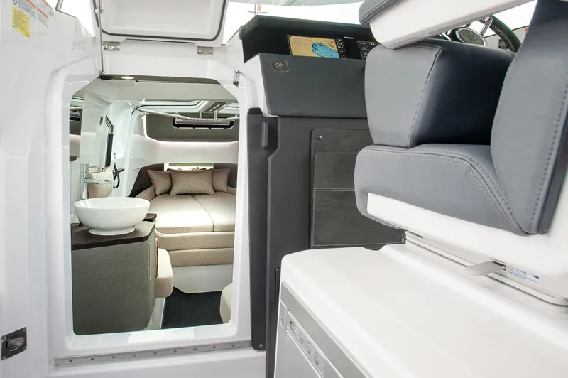 Slide: The Image of Interior of 2025 Axopar 37 XC CROSS CABIN, featuring modern seating and cozy sleeping area. - 28