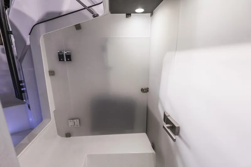 Slide: The Image of Interior of 2025 Axopar 37 XC CROSS CABIN, featuring sleek, modern design with frosted glass door. - 37