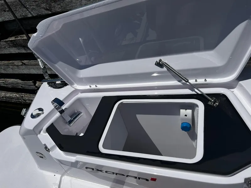 Slide: The Image of Open storage compartment on 2025 Axopar 37 XC CROSS CABIN boat, showcasing sleek design. - 10