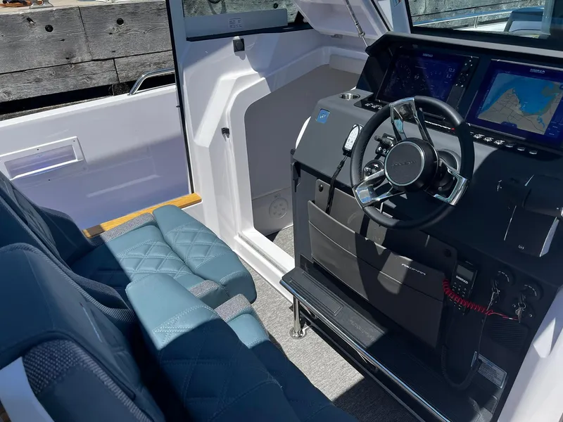 Slide: The Image of Interior of 2025 Axopar 37 XC CROSS CABIN with modern steering and navigation system. - 13