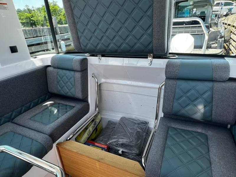 Slide: The Image of Luxurious seating inside 2025 Axopar 37 XC CROSS CABIN with quilted upholstery and modern design. - 16