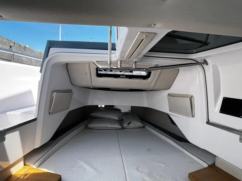 Slide: The Image of Interior cabin of 2025 Axopar 37 XC CROSS CABIN, featuring modern design and comfortable bedding. - 21
