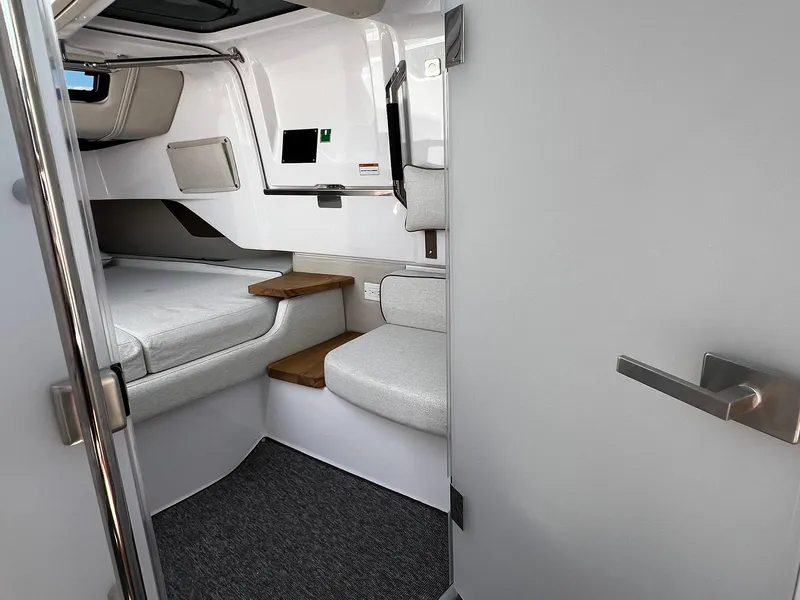 Slide: The Image of 2025 Axopar 37 XC CROSS CABIN interior with modern seating and sleek design. - 23