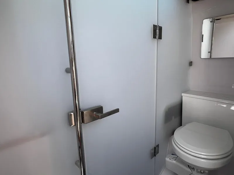 Slide: The Image of Bathroom interior of 2025 Axopar 37 XC CROSS CABIN with modern fixtures. - 25