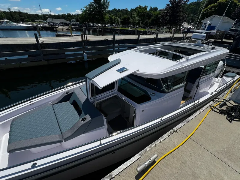 Slide: The Image of 2025 Axopar 37 XC CROSS CABIN docked, showcasing sleek design and spacious deck. - 3