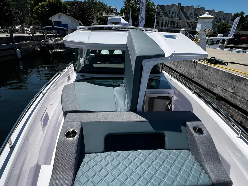 Slide: The Image of 2025 Axopar 37 XC CROSS CABIN boat docked, featuring sleek design and comfortable seating. - 4