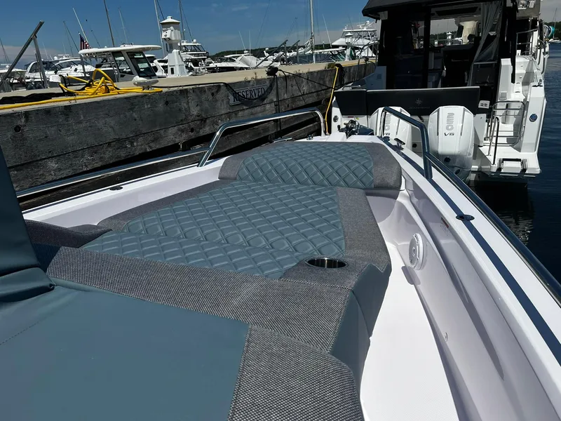 Slide: The Image of 2025 Axopar 37 XC CROSS CABIN boat with cushioned deck, docked at marina. - 6