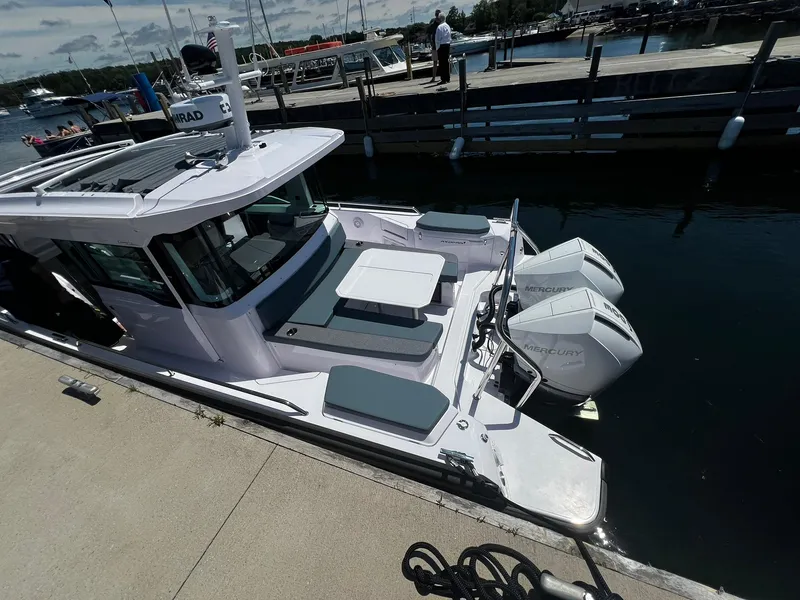 Slide: The Image of 2025 Axopar 37 XC CROSS CABIN docked, featuring dual Mercury outboard engines and spacious seating area. - 8