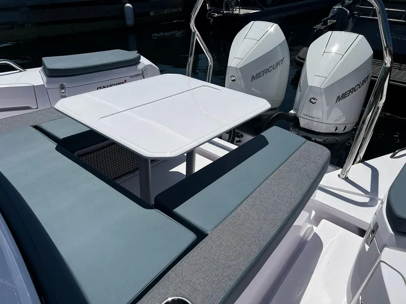 Slide: The Image of 2025 Axopar 37 XC CROSS CABIN with seating area and dual Mercury engines. - 9