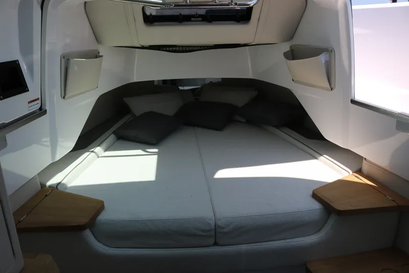 Slide: The Image of Interior cabin of 2025 Axopar 37 XC Cross Cabin with cozy bedding and cushions. - 20
