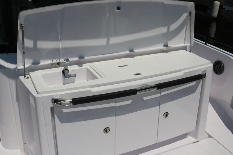 Slide: The Image of 2025 Axopar 37 XC Cross Cabin boat sink and storage area. - 9