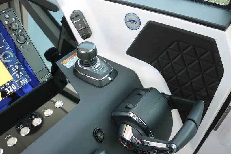 Slide: The Image of Control panel of 2025 Axopar 37 XC Cross Cabin with joystick and display screen. - 14