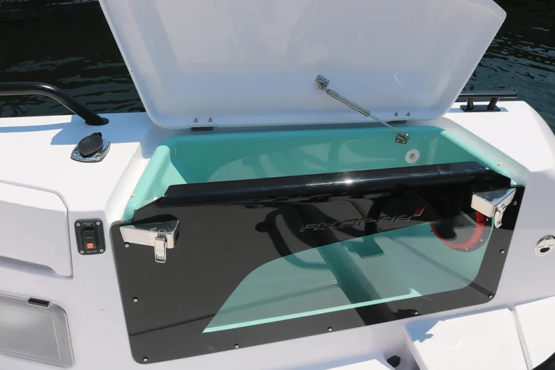 Slide: The Image of 2025 Axopar 37 XC Cross Cabin storage compartment with open lid, showcasing sleek design. - 5