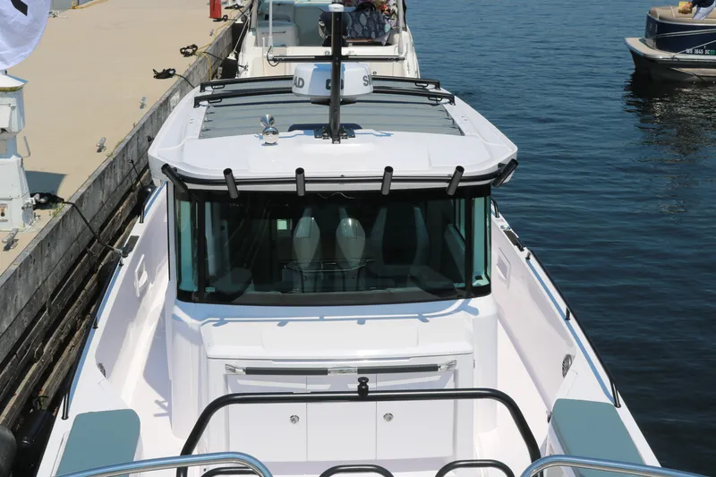 Slide: The Image of 2025 Axopar 37 XC Cross Cabin boat docked at marina, top view. - 2