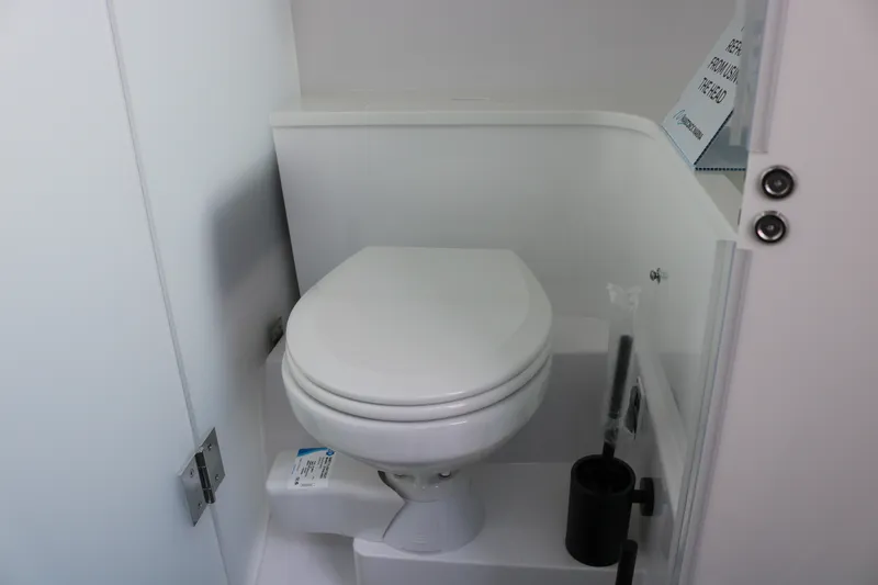 Slide: The Image of 2025 Axopar 37 XC Cross Cabin bathroom with modern white toilet and sleek design. - 27
