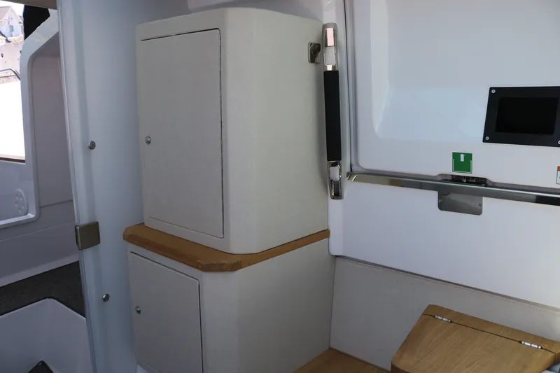 Slide: The Image of Interior of a modern cabin with wood and fabric elements, cabinets, and a small screen. - 22