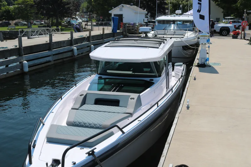 The Image of 2025 Axopar 37 XC Cross Cabin docked at a marina, showcasing sleek design and modern features. - 0