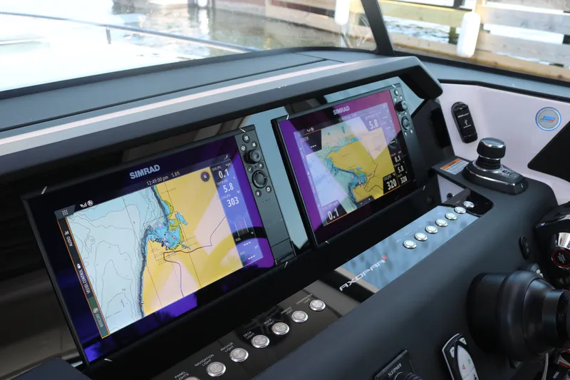 Slide: The Image of 2025 Axopar 37 XC Cross Cabin dashboard with dual Simrad navigation screens. - 16