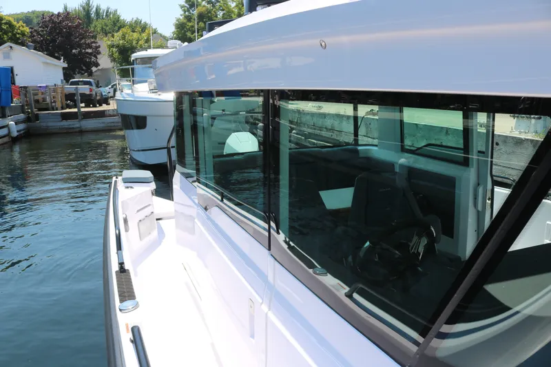 Slide: The Image of 2025 Axopar 37 XC Cross Cabin docked, showcasing sleek design and modern features. - 10