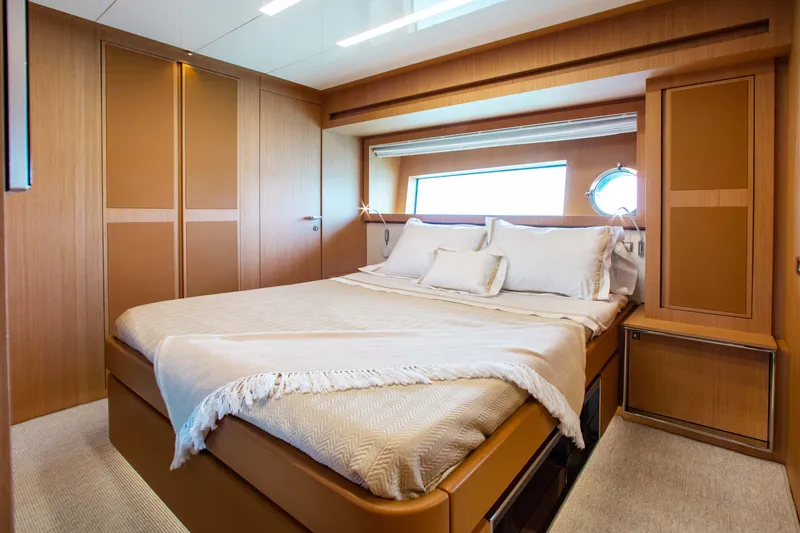 Slide: The Image of Luxurious bedroom interior of 2016 Riva 88' Florida yacht with elegant wood finishes. - 15