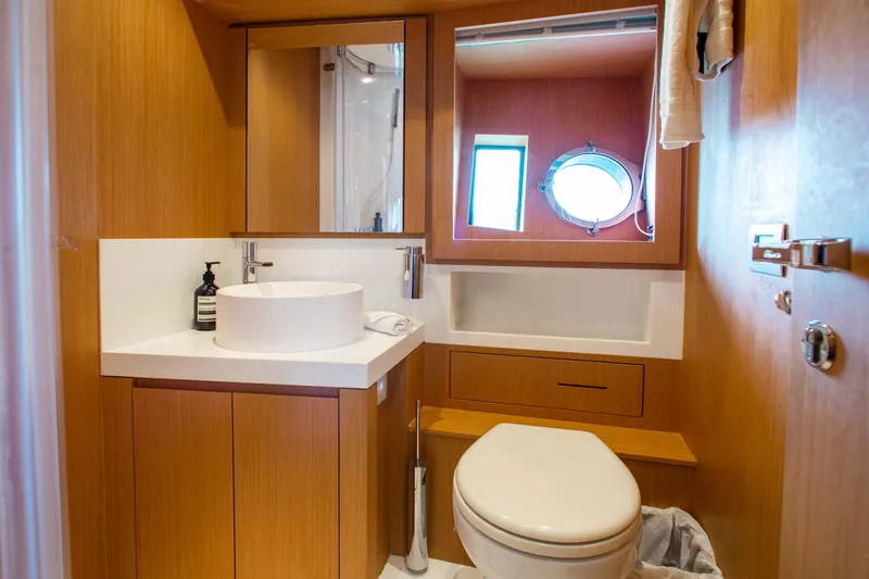 Slide: The Image of Luxurious bathroom in 2016 Riva 88' Florida yacht with modern fixtures and wooden cabinetry. - 19