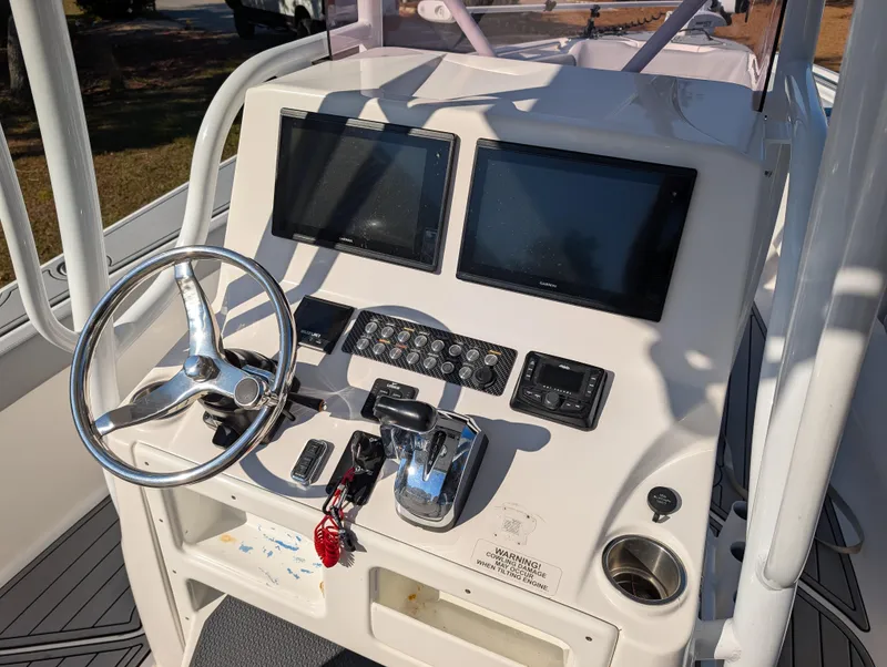 Slide: The Image of 2020 Blue Wave 2800 Makaira boat dashboard with dual screens and controls. - 15