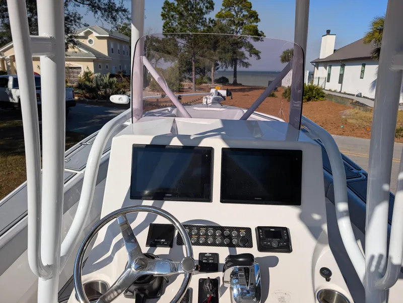Slide: The Image of 2020 Blue Wave 2800 Makaira boat dashboard with dual screens and steering wheel. - 17