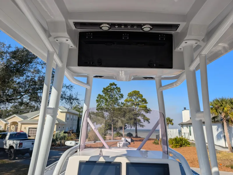 Slide: The Image of 2020 Blue Wave 2800 Makaira boat console with electronics, framed by a sunny outdoor setting. - 18