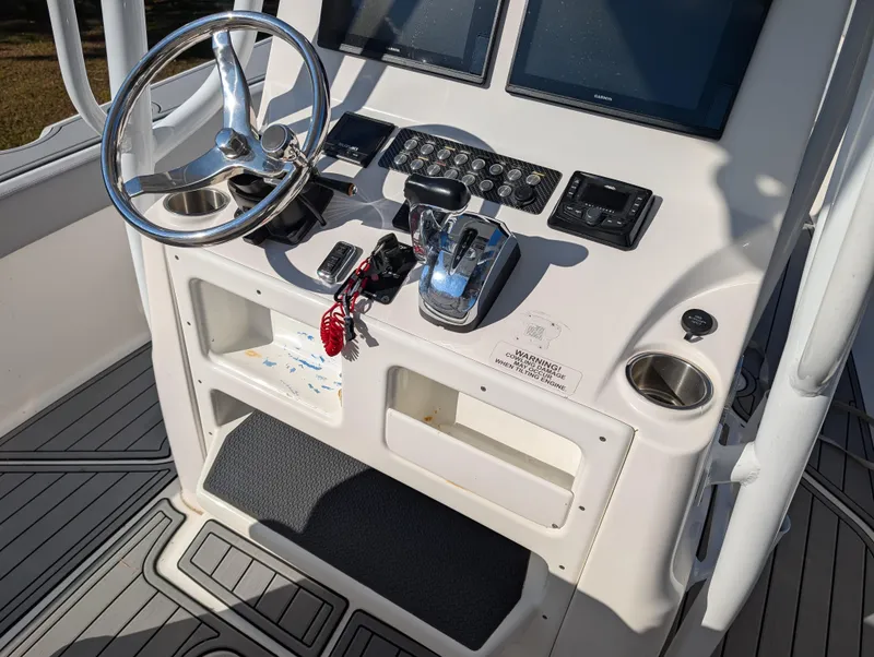 Slide: The Image of Control console of 2020 Blue Wave 2800 Makaira boat with steering wheel and navigation equipment. - 23