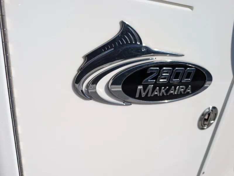 Slide: The Image of 2020 Blue Wave 2800 Makaira boat emblem on white surface. - 26