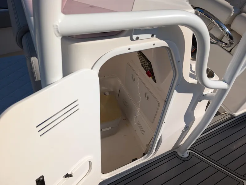 Slide: The Image of 2020 Blue Wave 2800 Makaira boat interior storage compartment with open door. - 29