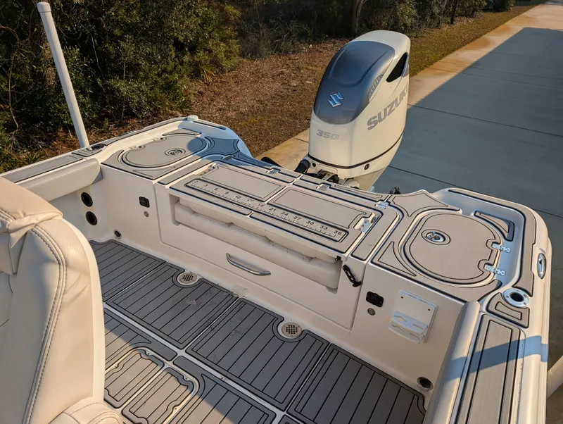 Slide: The Image of 2020 Blue Wave 2800 Makaira boat with Suzuki engine, featuring spacious deck and seating area. - 30