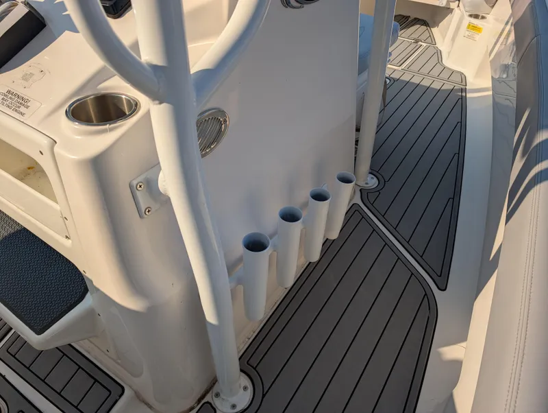 Slide: The Image of 2020 Blue Wave 2800 Makaira boat interior with rod holders and cup holder. - 36