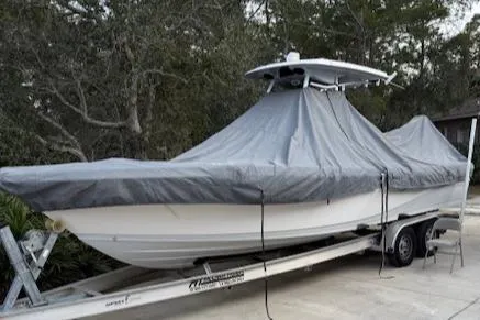 Slide: The Image of 2020 Blue Wave 2800 Makaira boat covered on trailer, parked outdoors. - 49