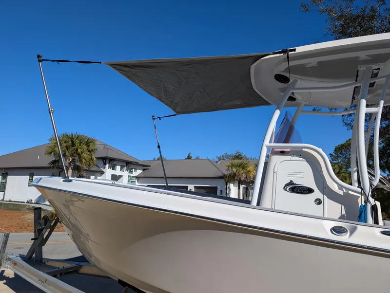 Slide: The Image of 2020 Blue Wave 2800 Makaira boat with sunshade, parked outdoors under clear blue sky. - 6