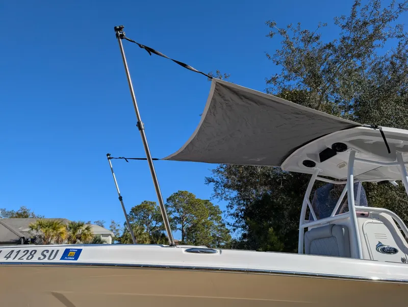 Slide: The Image of 2020 Blue Wave 2800 Makaira boat with sunshade, clear sky background. - 7