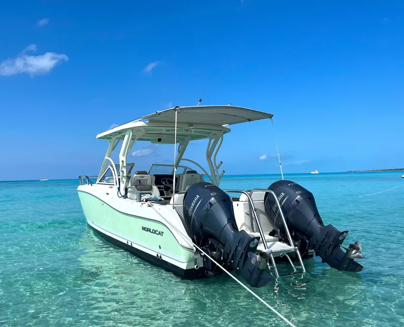 Slide: The Image of 2021 World Cat 255DC boat in clear turquoise water, featuring dual outboard engines. - 1