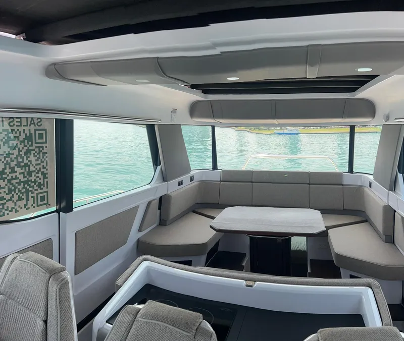 Slide: The Image of Interior of 2025 Axopar 45 XC Cross Cabin with modern seating and table. - 15