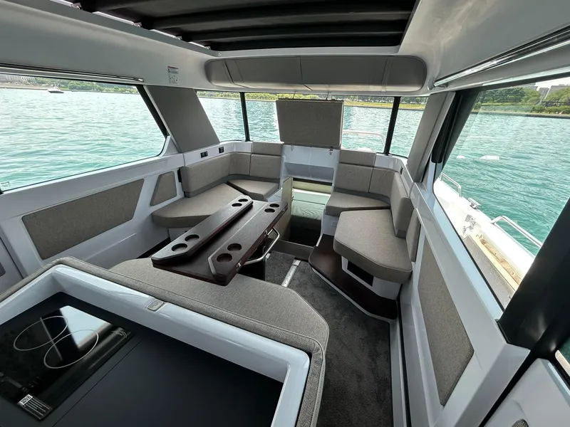 Slide: The Image of Luxurious interior of 2025 Axopar 45 XC Cross Cabin with modern seating and table. - 22