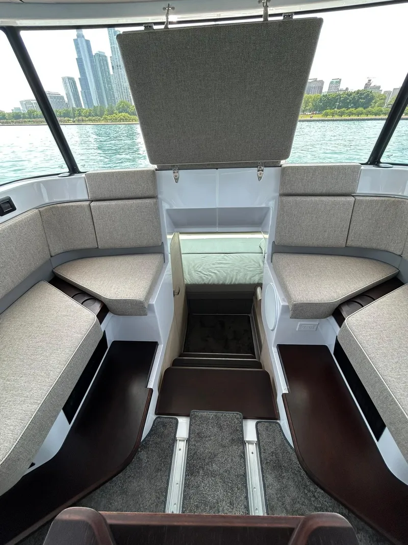 Slide: The Image of Interior of 2025 Axopar 45 XC Cross Cabin with seating and city skyline view. - 23