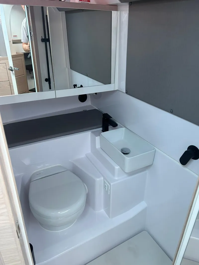 Slide: The Image of 2025 Axopar 45 XC Cross Cabin bathroom with modern fixtures and compact design. - 30
