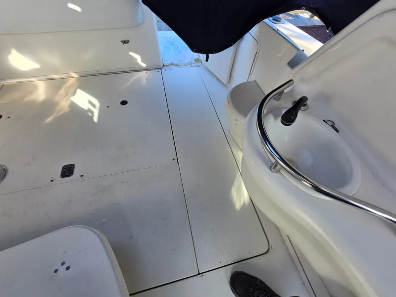 Slide: The Image of Interior view of 2000 Sea Ray 310 Sundancer boat, featuring a compact sink area. - 10