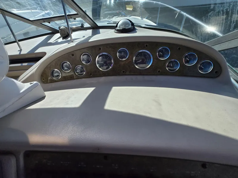 Slide: The Image of Dashboard of a 2000 Sea Ray 310 Sundancer boat with multiple gauges. - 15