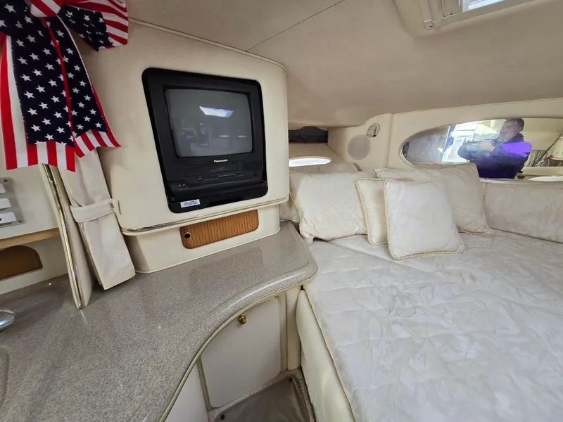 Slide: The Image of Interior of 2000 Sea Ray 310 Sundancer with TV and American flag decor. - 22