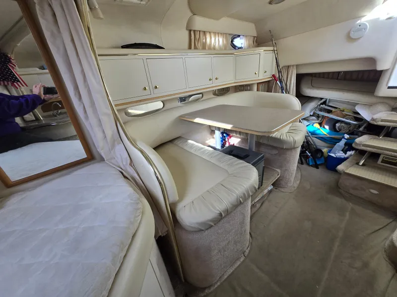 Slide: The Image of Interior of 2000 Sea Ray 310 Sundancer boat with seating and storage. - 26