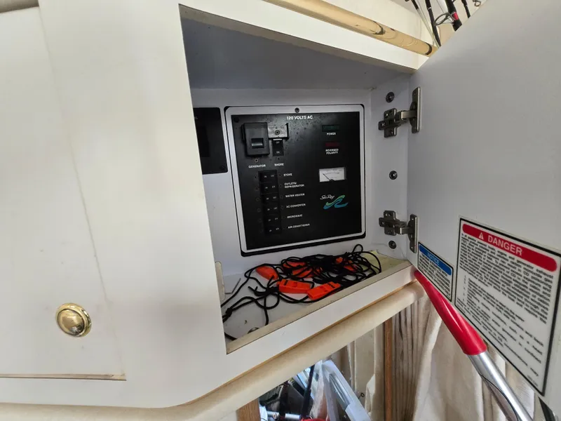 Slide: The Image of Electrical panel inside a 2000 Sea Ray 310 Sundancer boat cabinet. - 29